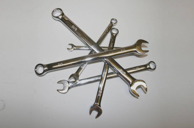 A group of wrenches are stacked on top of each other.